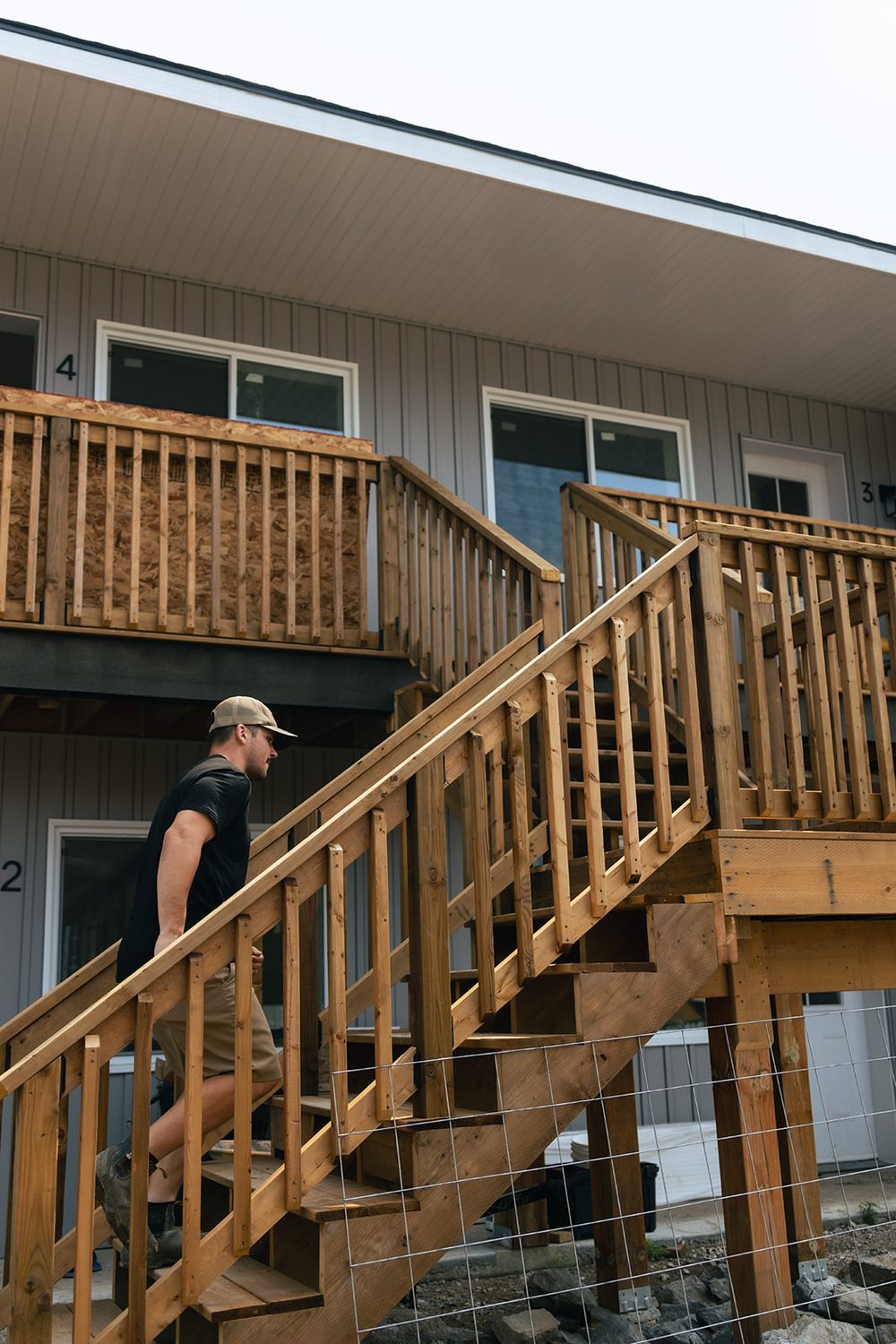 Exterior stairs and entry decks serving the upper units